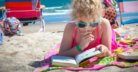 girl reading on beach