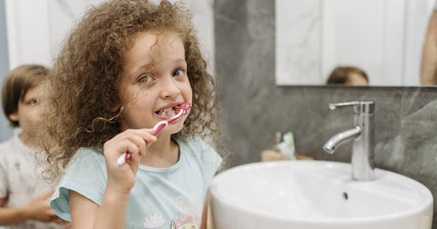 girl brushing teeth