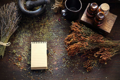 note pad on table full of dried herbs