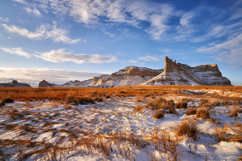 Landscape shot of mountains, blue skies and snow on the ground