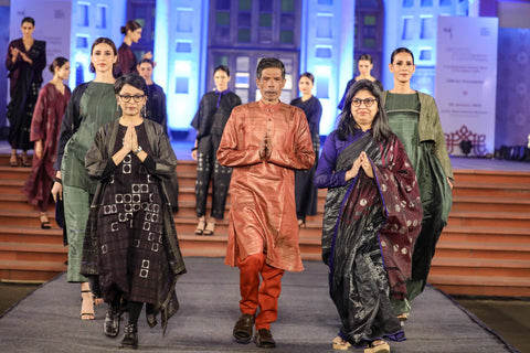 "Karomi's Creative Head and Founder, Sarita Ganeriwala, and Co-founder Sarika Ginodia, alongside our skilled weaver, gracefully concluding the show on the ramp. A powerful image symbolizing the collaborative journey from craftsmanship to the runway, where tradition and innovation walk hand in hand."