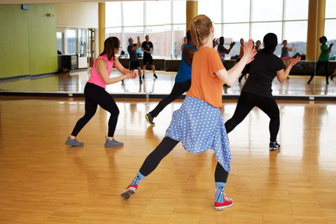 Students practicing a dance routine in a studio
