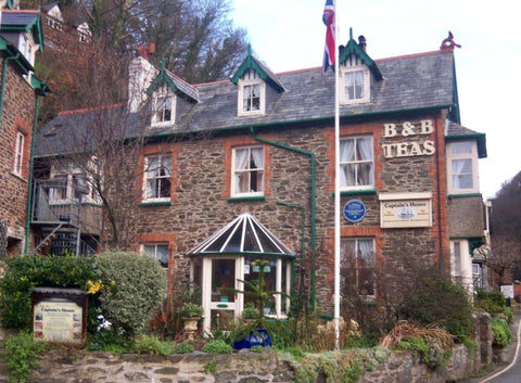 B&B's Tea House in the U.K. The tea house is a stone building with green trim around the windows.