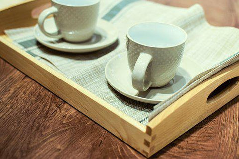 Two white teacups on a tray