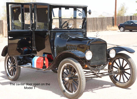 A Model T car painted black with the door open. Caption reads 'The center door open on a Model T'.
