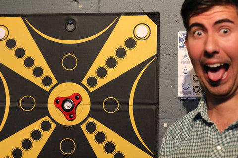 Excited KOOBA player sticks out his tongue and pulls a funny face in front of the board. 