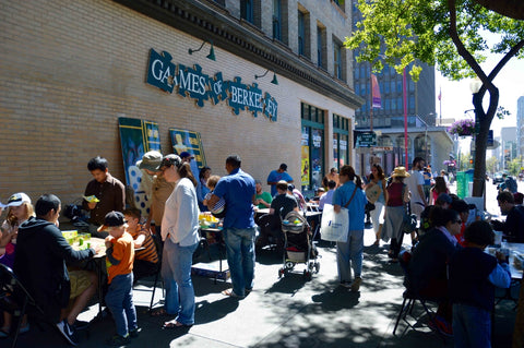 Game lovers are playing locally made board games outside of Games of Berkeley in the sunshine on Father's Day.