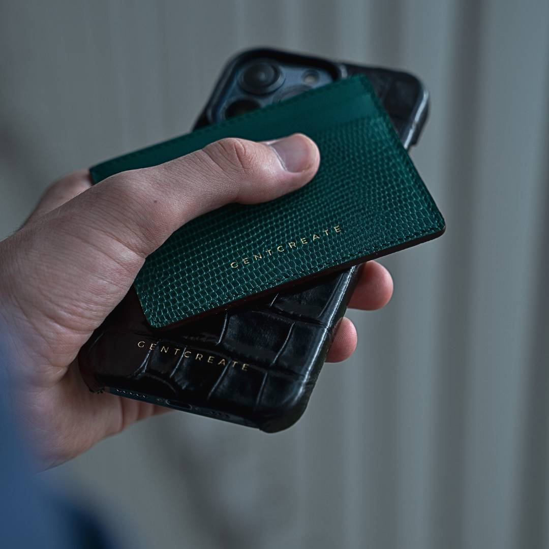 The man is holding a luxury leather cardholder and iPhone case by Gentcreate Luxury Tech Brand