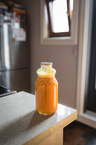 bottle of orange juice on kitchen bench