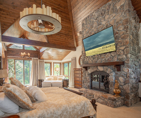 main bedroom featuring 65" Sony TV and custom window treatments