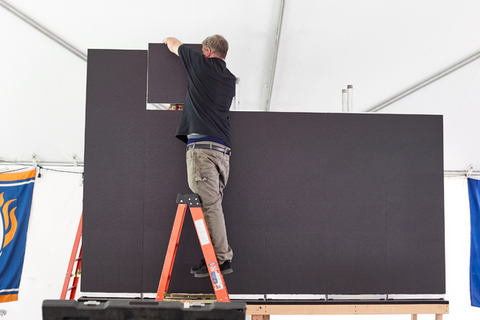 ListenUp technicians build the 10ft wide big screen