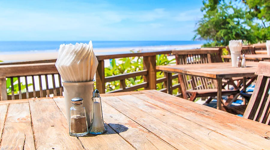 A wooden table accompanied by bamboo disposable napkins.