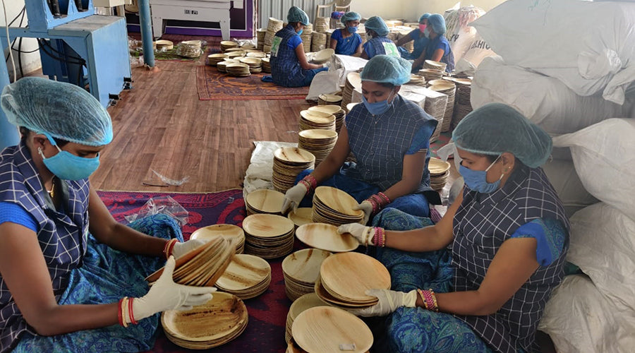 Womens making palm leaf plates