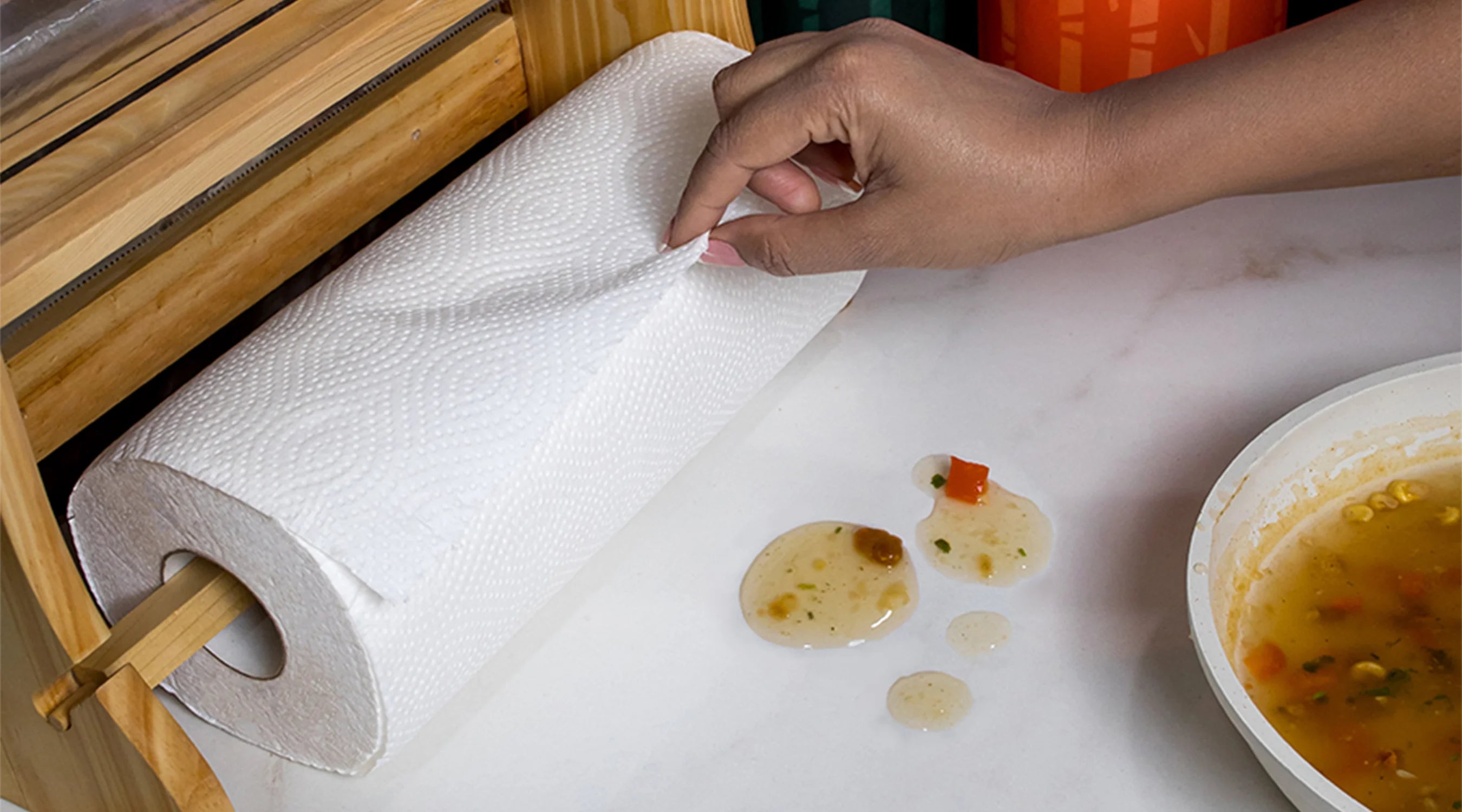 A person placing a Bamboo Cleaning wipe on a counter to clean and sanitize the surface.