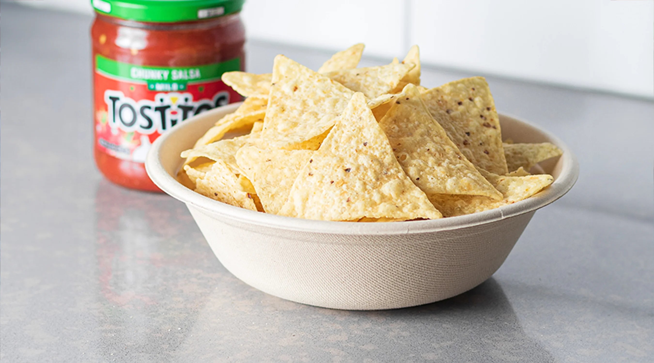 Tostitos tortilla chips in a bagasse bowl.