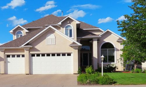 Image shows a house with yard