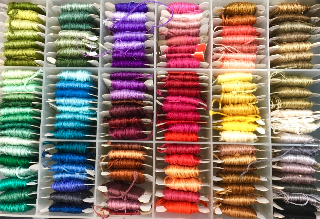 A rainbow of embroidery floss wrapped on cards 