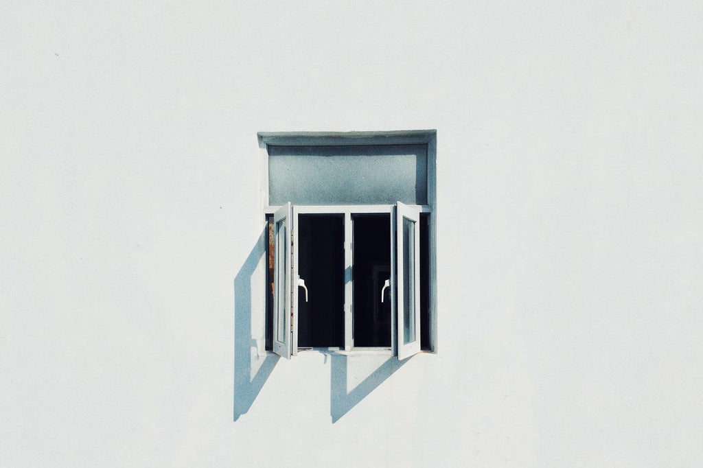 minimalist picture of a vintage window open from the outside