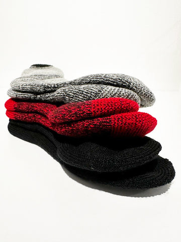 angled picture displaying three pairs of socks stacked together (bottom) black, (middle) red, (top) natural