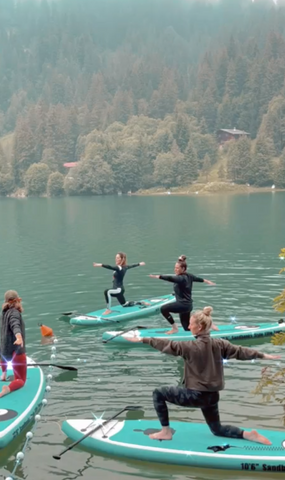 Paddleboard yoga on a lake in Switzerland with Zeller Yoga
