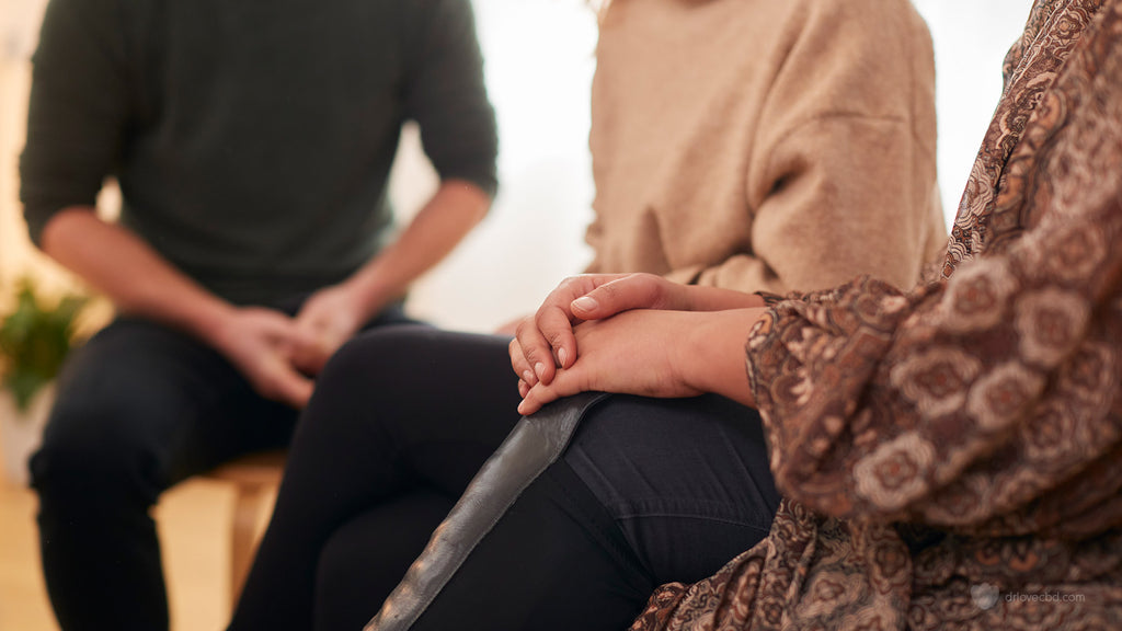 several adults sitting in a circle in discussion during a mental health support group