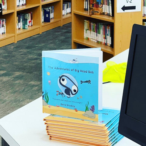 "The Adventures of Big Head Bob" by David Bradley, a great book for children with anxiety, is displayed in a public library.