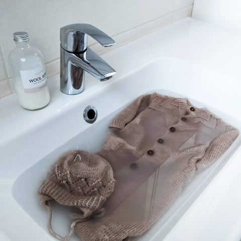 Step 2: Fill the sink with cold water and wool soap and place the piece in it.