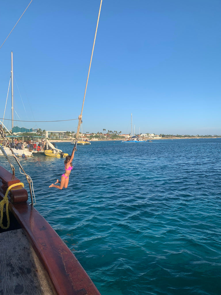 Amber swinging off the pirate boat in Aruba