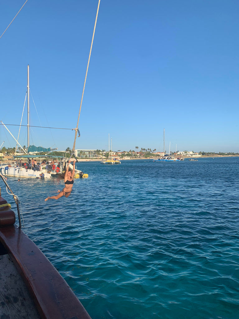 Samantha swinging off the pirate boat in Aruba