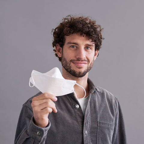 man holding a respirator face mask