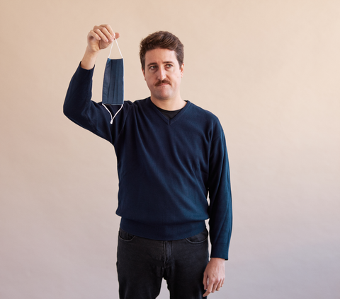 man holding a cloth face mask