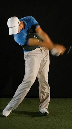 Golfer using training aid to eliminate his slice in a single swing