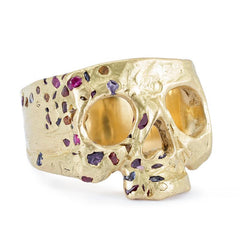 Gold skull ring with pink and purple gems added in a confetti-like pattern