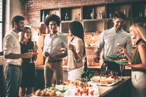 Group of friends enjoying home dinner party in brick loft