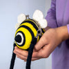 A felt purse in the shape of a smiling bumblebee, back