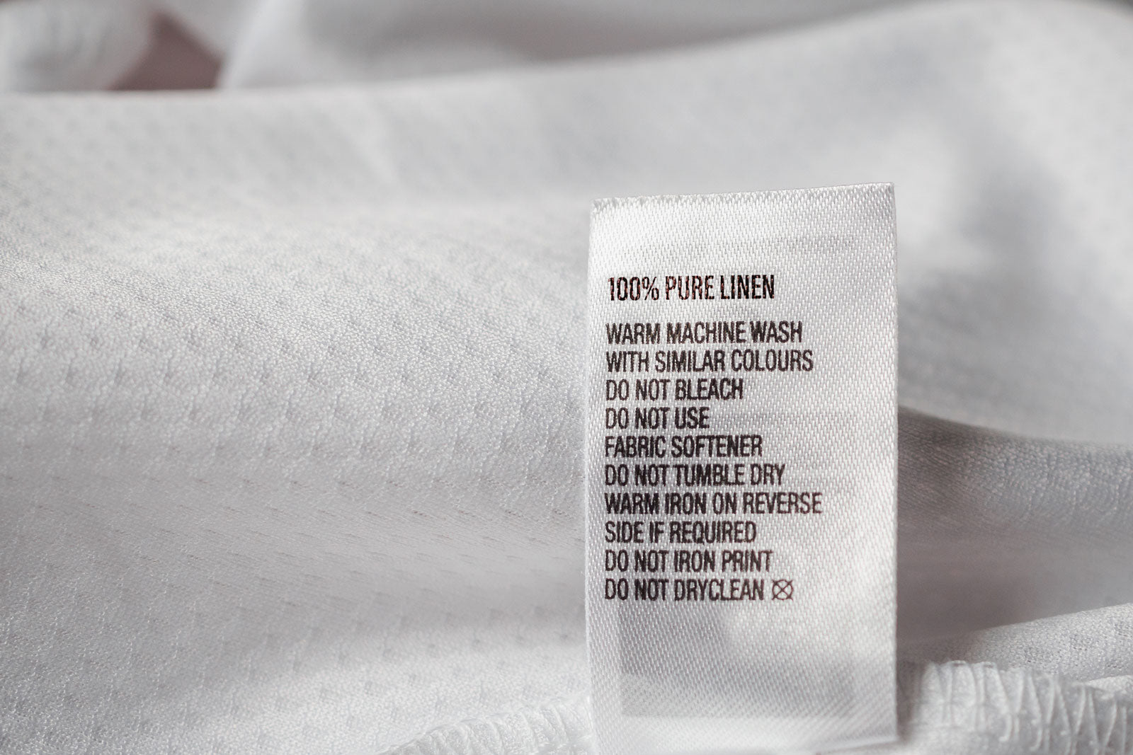 Laundery-Care-Tag-Pure-Linen-Fabric-On-White-Fabric