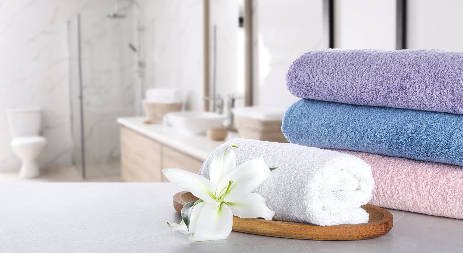 Luxury towels on a marble table in bathroom