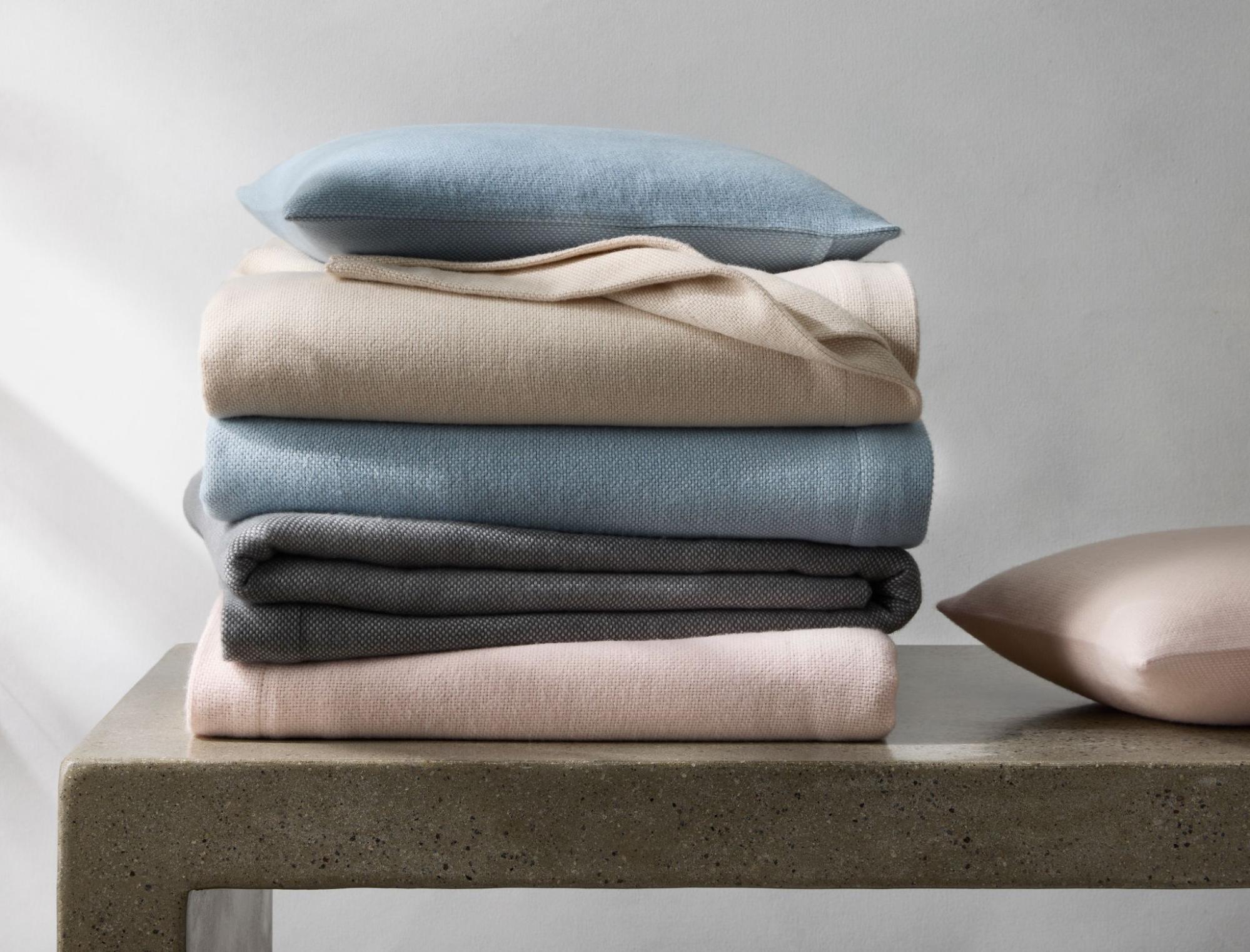 Matouk Webster Blanket (top to bottom) in Dune, Hazy Blue, Pink and Charcoal