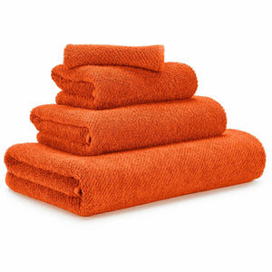 orange bath mat and towels