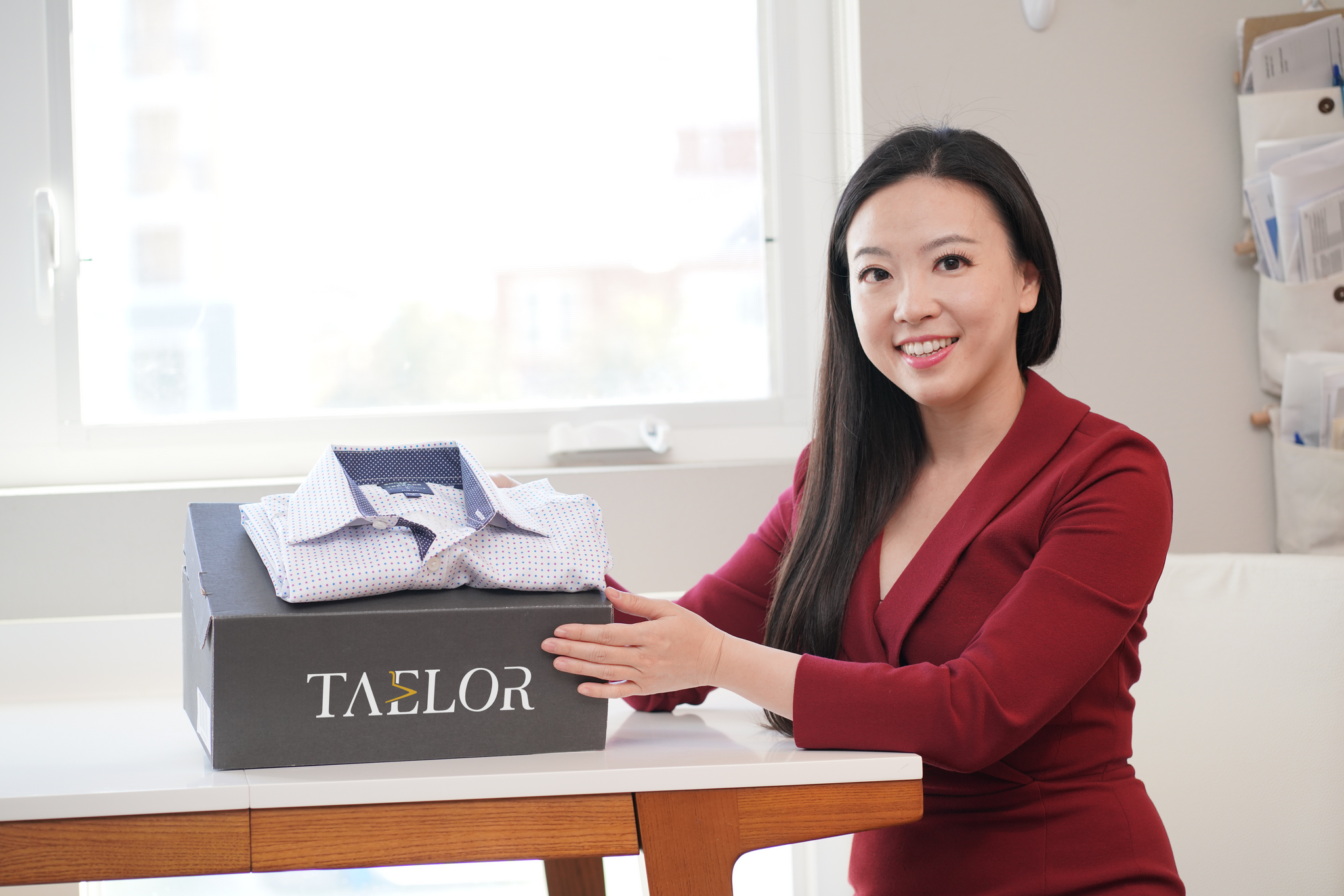 Taelor founder holding menswear rental subscription box  
