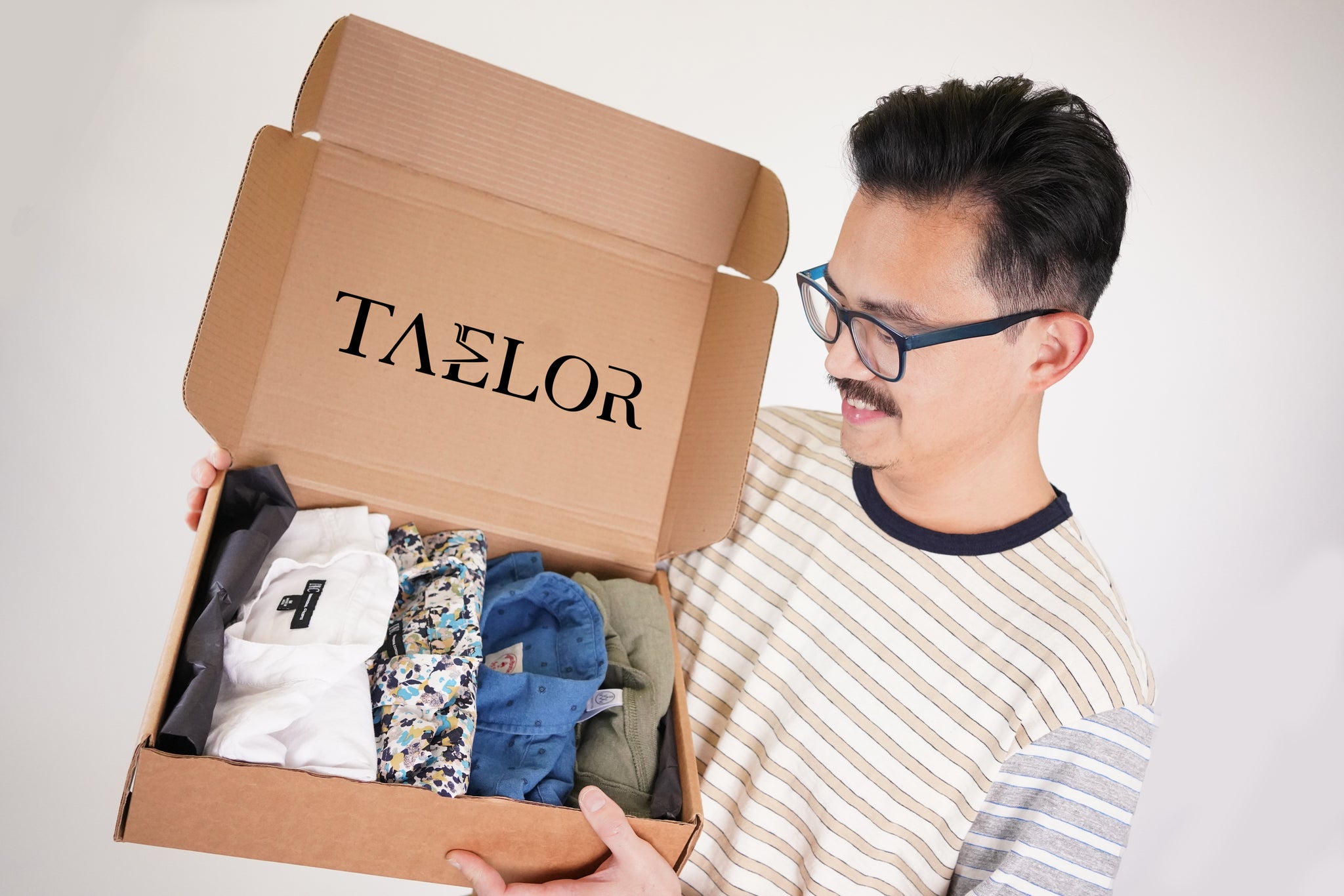 Taelor menswear rental subscription box man holding