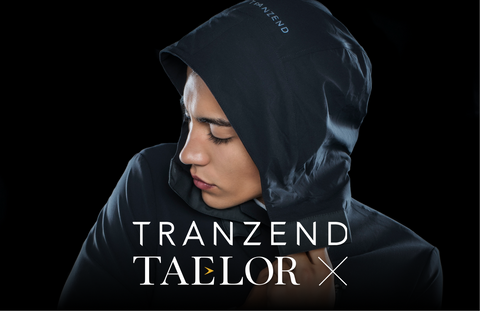 A model in a black rain jacket/suit from TRANZEND