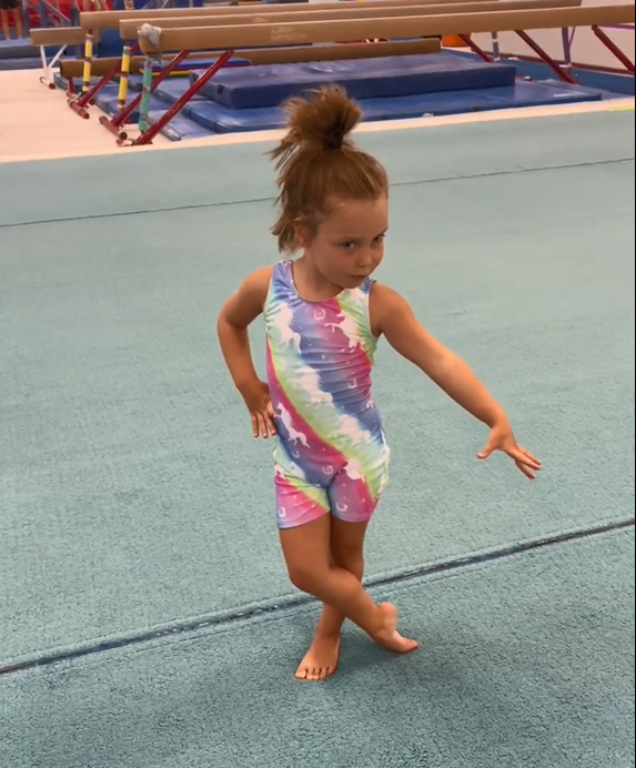 Young Gymnasts wears stripes rainbow pattern biketard/unitard for gymnastics practice