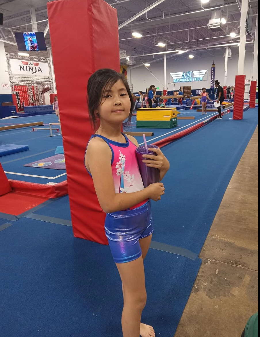 JOYSTREAM Girl wear parisian-themed gymnastics leotard