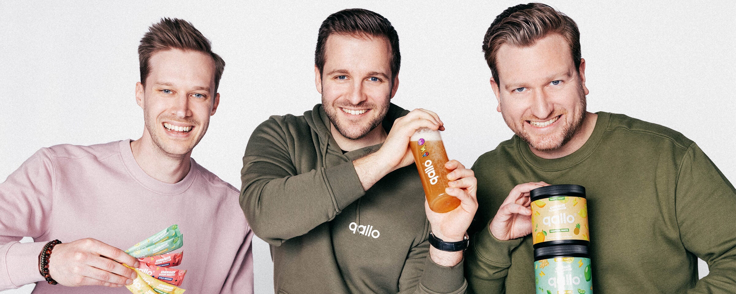 The Qallo founders - Niels Peetermans, Alexander Van Laer & Moos Tits - holding the Qallo products.