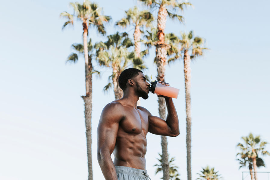 muscular man drinking protein shake