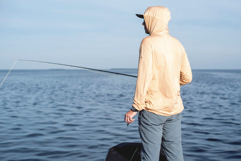 Fisherman wearing the Angler Bamboo Hoodie while inshoring fishing.