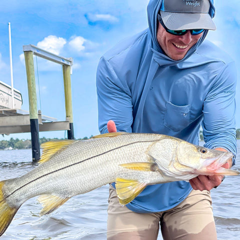Ryan Morie catching a snook in the Angler Crossover Bamboo Hoodie. 