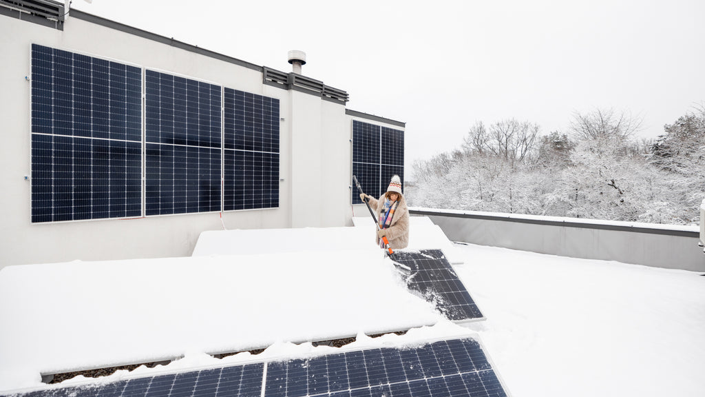 Snow management plan in action—removing snow from solar panels with efficient tools