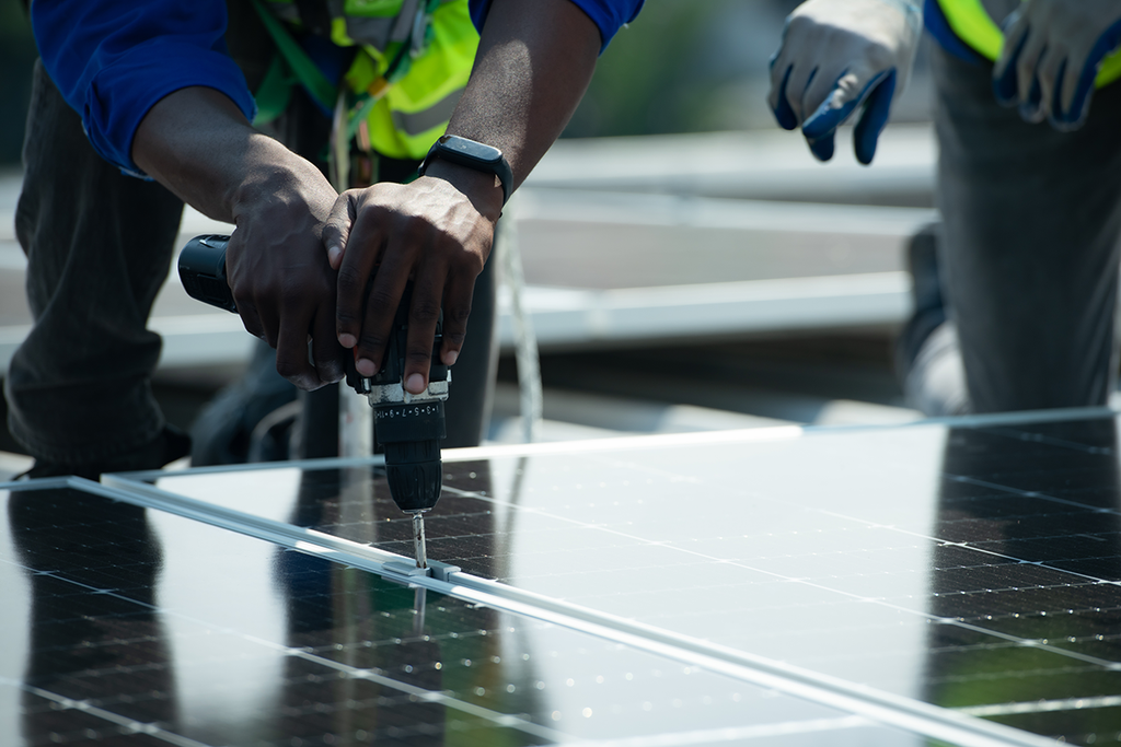 Technician performing a professional inspection of solar panels